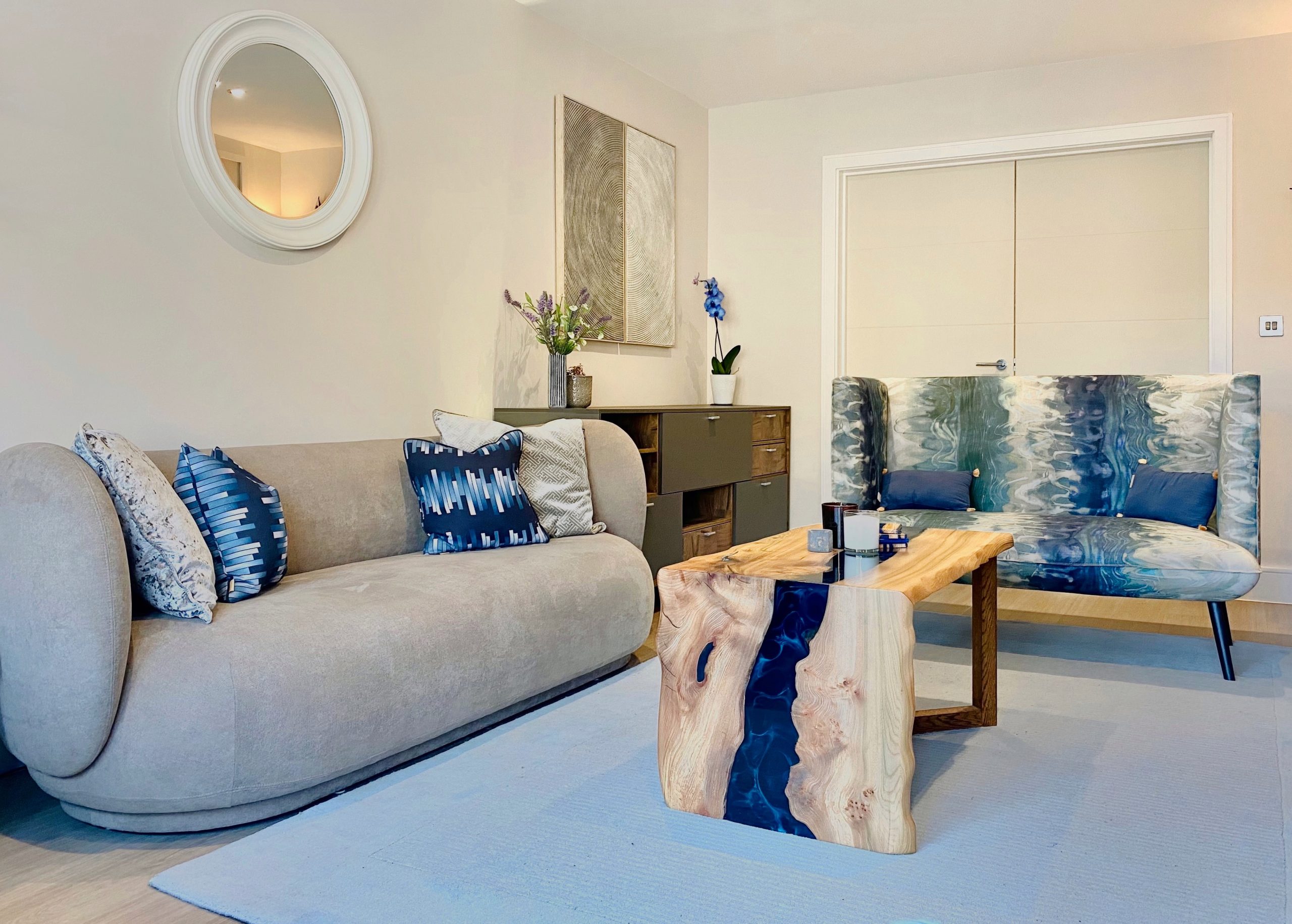 Coggeshall living room with cream sofa, live edge coffee table and blue accent chairs